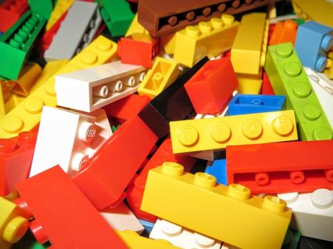 Close up of white, yellow, red, blue, and green LEGO bricks.