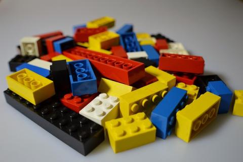 Assorted black, white, blue, yellow, and red LEGO bricks.