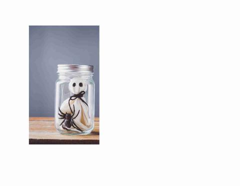 Ghost in a mason jar made of a piece of white cloth that is tied with black string. There is a toy black spider and a mini hand below it.