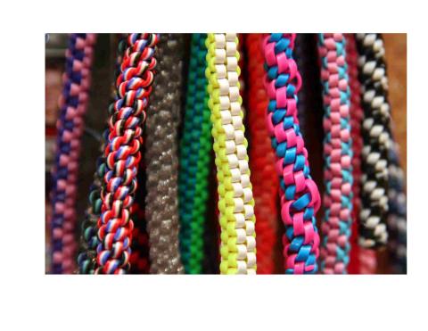 Colorful plastic strings that are knotted into a spiral or a square.