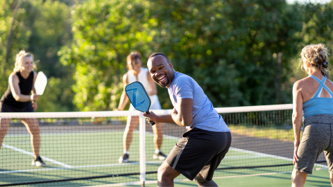 group of people playing pickleball