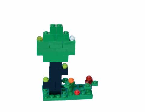Simple tree made of LEGO with smaller bricks made to resemble flowers.