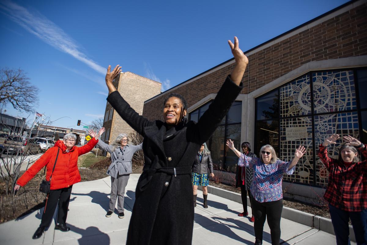 A group of dancing women in front of the Library