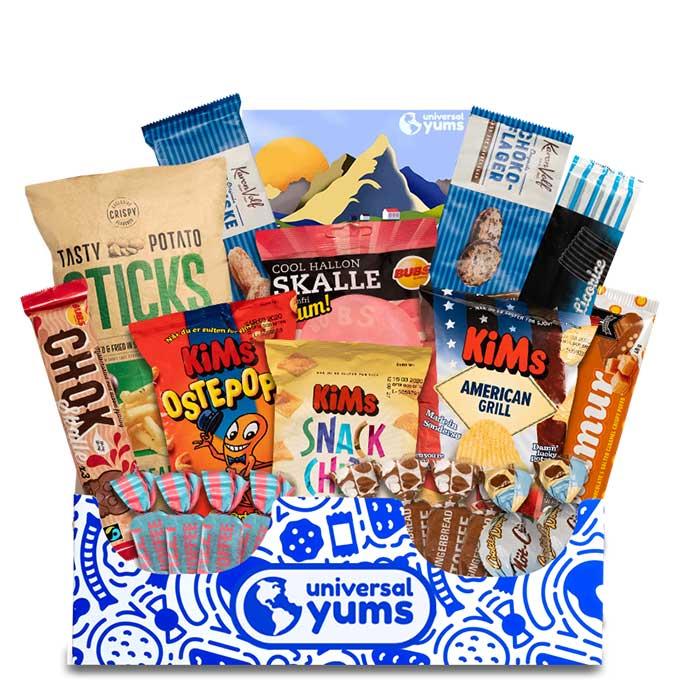 a blue and white Universal Yums box overflowing with different snacks