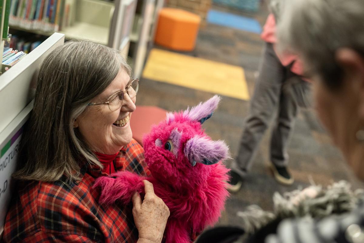 Photo of woman laughing with puppet