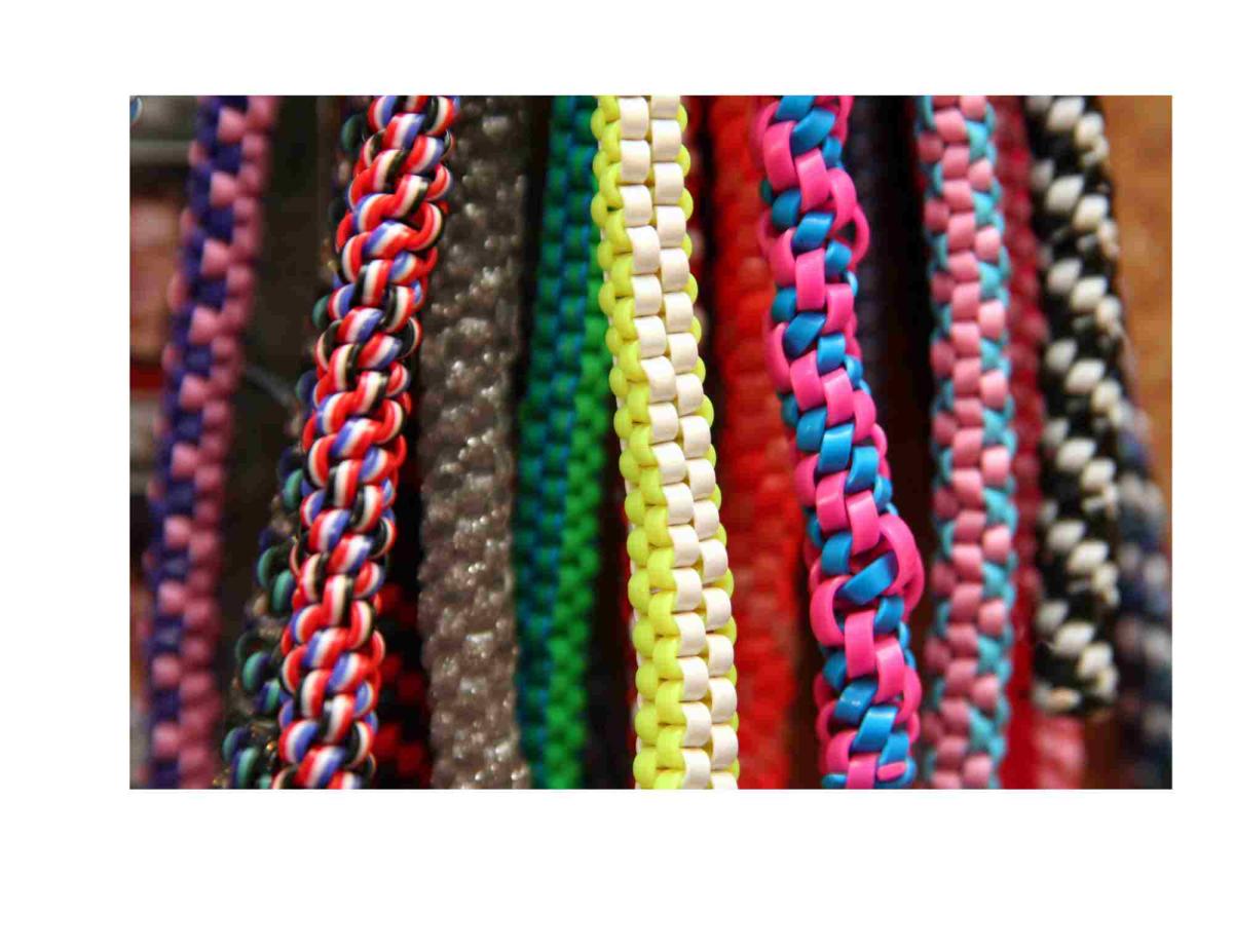 Colorful plastic strings that are knotted into a spiral or a square.