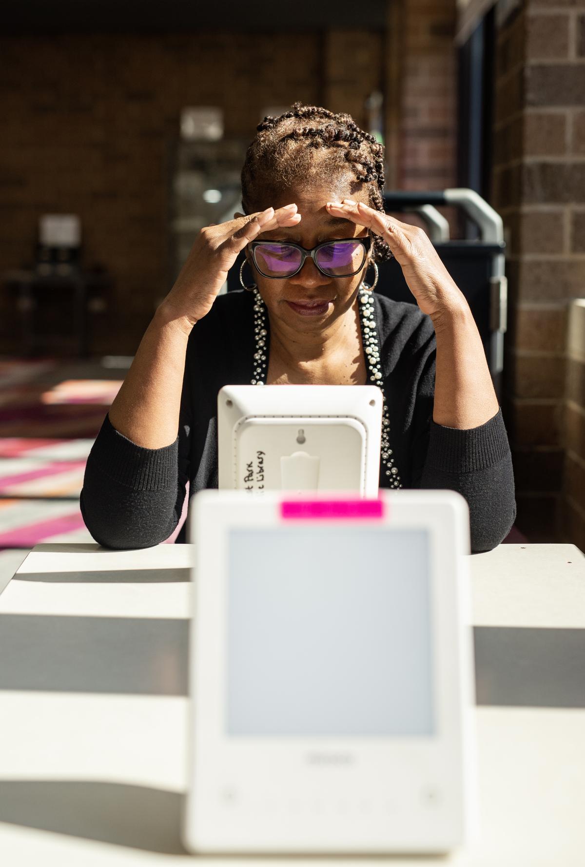 Older patron looking at a computer