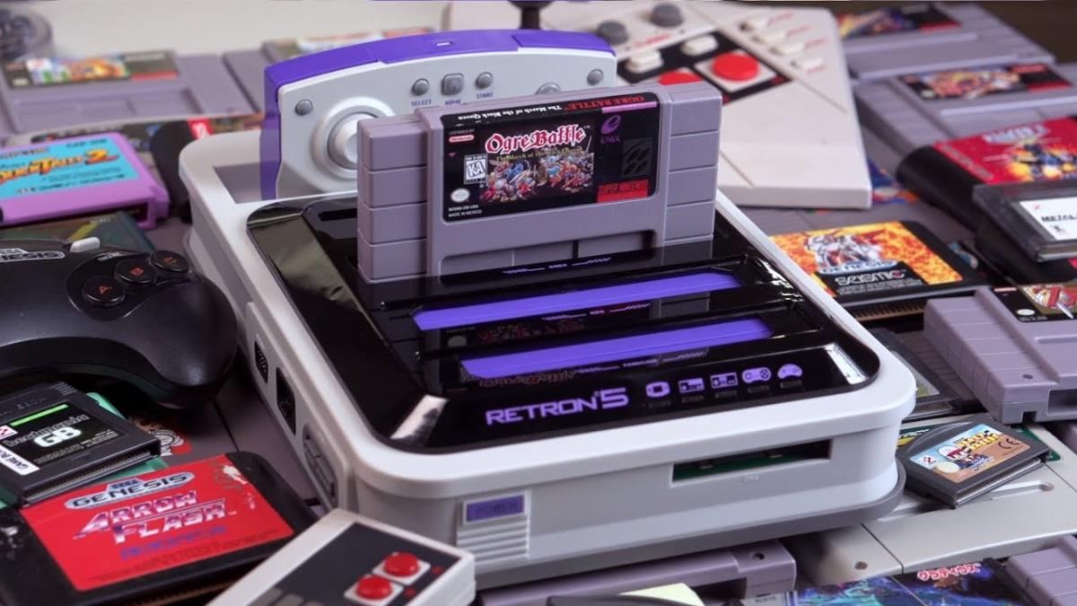 a gray and purple retro style console with a gray cartridge sticking out of it
